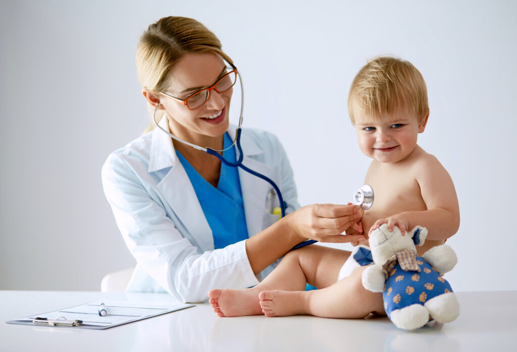 female doctor is listening kid with a stethoscope in clinic